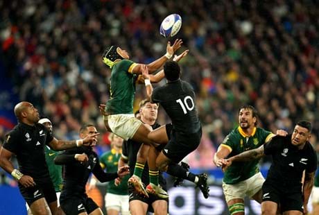 South Africa's Kurt Lee Arendse (Left) And New Zealand's Richie Mo'unga Jump For The Ball